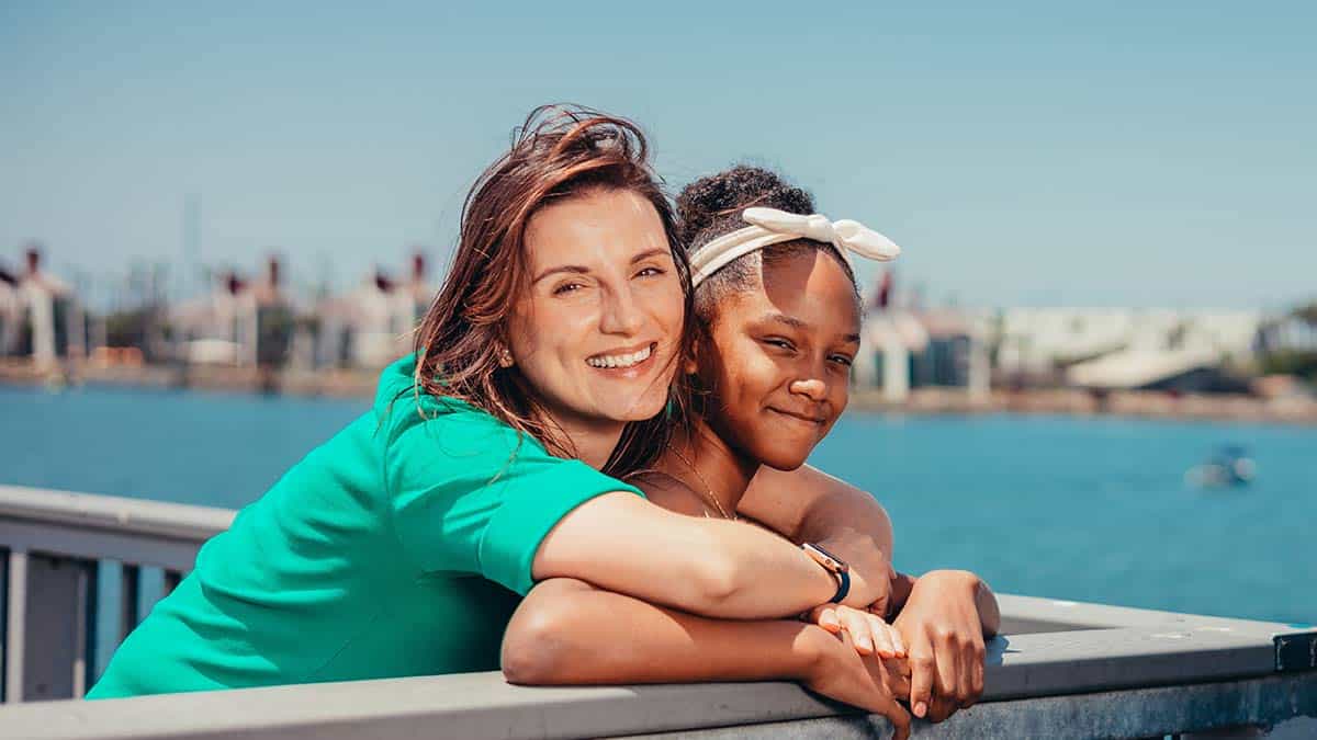 A foster carer and child together by the water